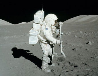 Astronaut collecting lunar soil