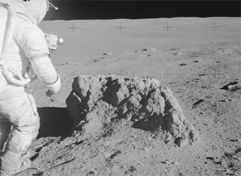 Apollo 14 astronaut checks out a lunar rock