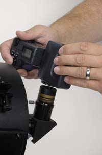 Digital camera for astrophotography held up to eyepiece